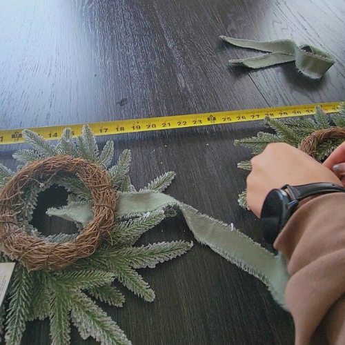 image of wrapping ribbon on the underside of wreath for dwelling envy's diy studio mcgee wreath dupe